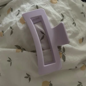 Lila XL hårklämma från Léonie - Stor stark hårklämma i lila XL från Léonie. Jätte bra verkligen men använder aldrig denna färgen (köpte flera samtidigt men använder aldrig den lila). Den är ljuslila försökte hitta på hemsidan men den lila va slutsåld men är exakt som på bilderna men ljuslila. Jag har tjockt o långt hår och den håller uppe hela håret jättebra hela dagen. (Den ena bilden är bara jämföra med en fjälontroll).