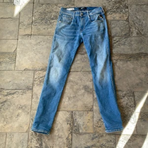 Replay Anbass Jeans - Snygga blå Replay Anbass jeans med ljusa slitningar, Knappt använda, Storlek W28 L32.