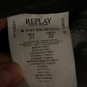 Replay Anbass mörkblå jeans 31/32 - Snygga mörkblå Replay Anbass jeans med klassisk femficksdesign och kontrastsömmar. Jeansen har raka ben och normal passform, tillverkade i slitstarkt denim med diskret Replay-logga på fickan. Perfekta för dig som gillar stilrena och tidlösa jeans.