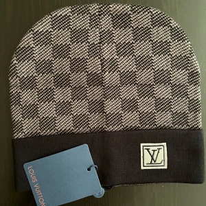 Lv Beanie -  🏷️ Brand: Lv 📐 Size: One size  🎨 Color: Black, Gray, White 🧵 Material: 100% Cotton 👕 Fit: Regular ⭐ Condition: New with tags ⚠️ Defects: None