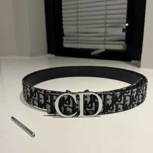 CD mönstrigt bälte 110cm - Säljer ett CD mönstrigt bälte. Storlek 110cm. Helt nytt. Skriv vid minsta intresse!!