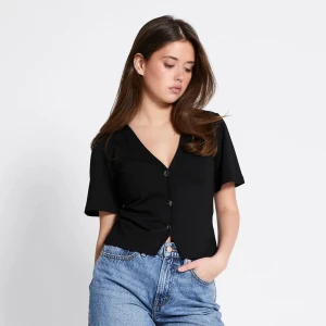 Svart croppad blus med v-ringning - Säljer en svart blus med korta ärmar och v-ringad hals. Toppen är v-ringad med knappar, jättefin och inga tecken på användning🩷