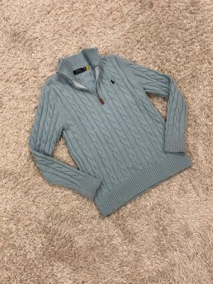 Polo Ralph Lauren stickad tröja/1/4zip ljusblå storlek M - En väldigt snygg stickad tröja från Ralph lauren i en ljusblå färg med den klassiska 1/4 zip dragkedjan🙌 tröjan är i ett nytt skick och har inga skador alls vilket gör detta till ett otroligt kap😇 vid frågor/prisförlag tveka inte en sekund med att höra av dig. OBS KOLLA IN LIKNANDE PLAGG I PROFILEN 🙌🙌🙌