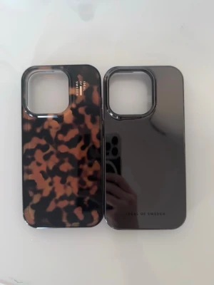  iPhone 15PRO skal  - Säljer två helt oanvända iPhone-skal från Ideal of Sweden i superfin design. Ett brunt tortoiseshell-skal och ett svart blankt som passar till allt.Samma modell på båda. Skicka gärna pm vid frågor eller prisförslag🤍