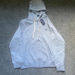 Polo Ralph louren zip hoodie  - Säljer en riktigt fräsch hoodie från Ralph louren hoddien e helt oanväd och har kvar lappen.Hör av er vid mer frågor:)