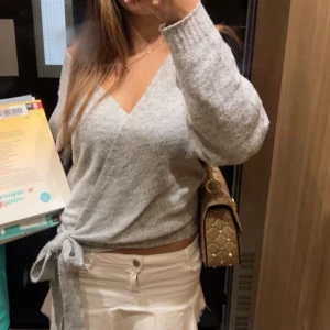 Grå omlott kofta med knyt - Säljer en supermysig grå omlott kofta med v-ringning och knyt i midjan. 