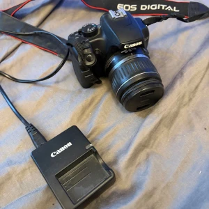 Canon eos 1000d - En canon eos 1000d kameran är i bra skick utan skador och funkar helt utmärkt. Det som syns på bilden fås med. Hör av er vid fler frågor. 