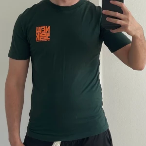 T-shirt  - Grön t-shirt. Storlek S. Med tryck fram och bak. 