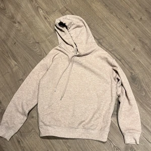 Beige hoodie från H&M Basics XS - Säljer en beige hoodie från H&M Basics i storlek XS. Tröjan har huva med snörning, ribbade muddar och en klassisk loose passform. Perfekt för chill dagar och enkel att matcha med jeans eller mjukisbyxor.