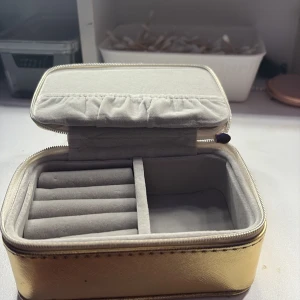 Guldig smyckesask - En snygg och kompakt smyckesask i guldig färg med mjuk, ljus insida. Perfekt för att organisera.