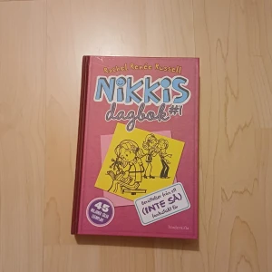 Nikkis dagbok #1 - Följ Nikki genom hennes dagbok när hon navigerar ny skola, elaka tjejer och förälskelser. Med roliga illustrationer och humoristiska berättelser är detta en perfekt bok för dig som gillar att läsa om vardagsdrama och vänskap.