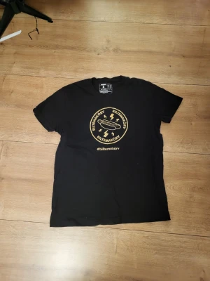 Svart Biltemakorv t-shirt i bomull - Cool svart t-shirt från Biltema med ett gult tryck av Biltemakorv och hashtag på bröstet. Klassisk rund hals och korta ärmar.