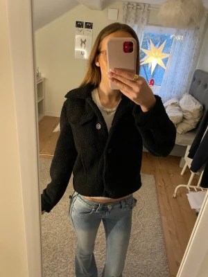 Svart teddyjacka från Pimkie  - Mysig svart teddyjacka från Pimkie i storlek XS. Jackan knäpps med knappar framtill och har 4 fickor, två lite högre upp och två vanliga vid sidorna💗