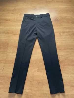 Mörkblå kostymbyxor - Säljer ett par super snygga kostym byxor från selected homme. Färg mörkblå. Storlek 42. De är aldrig använda nya med prislapp. Säljer för att de tyvärr var för små för mig.   Frakt sker samma dag som köp!:) Snabbt köp billigare pris.