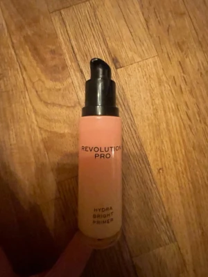Revolution Pro primer serum - Säljer en Revolution Pro Hydra Bright Primer och Luminous Primer Serum i pumpflaska. Båda har en ljusrosa färg och kommer i smidig glasflaska med svart pump. Perfekt för att ge huden extra lyster och fukt innan sminket.
