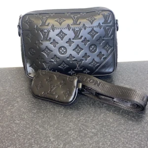 Svart väska-set – helt ny - .Helt ny svart väska-set med axelrem och liten pouch. Elegant design med klassiskt mönster. Aldrig använd, perfekt skick.