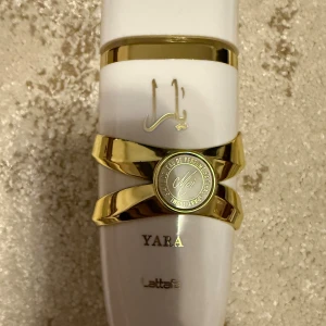 Lattafa Yara Moi Eau de Parfum 100ml - Trendig parfym från Lattafa med namnet Yara. Snygg design med guldiga detaljer. Perfekt för dig som vill sticka ut med en unik flaska i samlingen. Endast sprayad 1-2 gånger, säljer eftersom det inte min doft. Doftar liten not av vanilj men lite myskig. Påminner väldigt mycket om en höst doft!