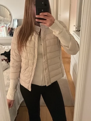Beige pufferjacka från Amisu - Säljer en beige pufferjacka från Amisu i storlek 36. Jackan är i trekvart som man ser på sista bilden. Är i en ljusrosa/lila om de är svårt att se färgen💘