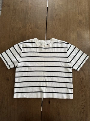 Vit och svart randig t-shirt från H&M - Vit och svart randig T shirt i stickat material från H&M. Storlek S. Knappt använd. 