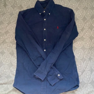 Blå skjorta från Ralph Lauren  - Blå skjorta från Ralph Lauren i storlek S. Fint skick till ett bra pris. Nypris: 1995kr Mitt pris: 299kr.                Vid frågor eller funderingar, tveka inte att höra av dig.