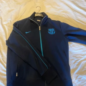 Barcelona zip tröja - En mörkblå zip tröja från Barcelona! Perfekt för en stor Barca supporter👍 Väldigt bra skick och storleken L men den sitter som Medium