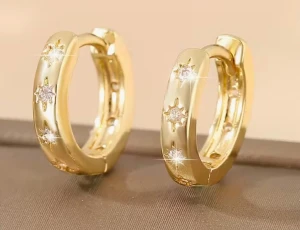 Guldiga örhängen med stjärndetaljer - Snygga guldiga hoops med små stjärnformade detaljer och glittrande stenar. Örhängena har en rund, chunky form och ger en lyxig känsla med sin blanka finish. Perfekta för dig som gillar att sticka ut med coola accessoarer.perfect for gift and if you buy now you will get freebies