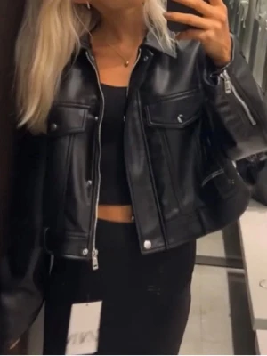 Ny skinnjacka från Zara - Ny svart bikerjacka med dragkedja och knappar i storlek S från Zara. Endast testad så nyskick! Nypris 599 kr, säljer för 220 kr. Kan hämtas i Kalmar eller skickas mot fraktkostnad.