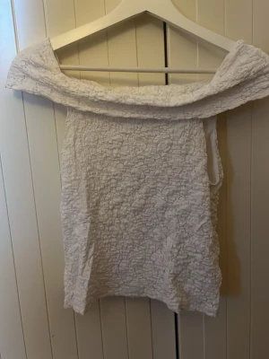 Vit off shoulder tröja - Säljer den här vita off shoulder tröjan med detaljer på. Använd ett fåtal gånger. Går att använda på många olika sätt. Väldigt fin.💗