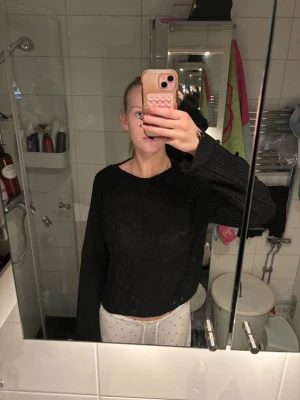 Svart stickad tröja med fransad kant - Säljer en svart stickad tröja med lång ärm. Tröjan har en loose fit och är perfekt för lager-på-lager. Enkel och stilren design som funkar till många outfits. Den har lite slitningar på ärmarna 