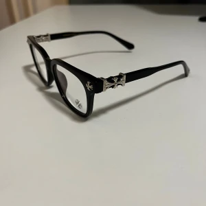 Chrome Hearts Blue-Light Glasses - ✨ Chrome Hearts Blue-Light Glasses – Premium Style ✨ 👓 Frame: Black acetate with iconic Chrome Hearts silver-tone details 🎨 Color: Black 🔵 Lenses: Blue-light blocking (non-prescription) 📌 Condition: Excellent – barely worn, like new 💎 Details: Signature CH cross motifs on temples + engraved arms 🧼 Fully cleaned & hygienic 🔥 Perfect for screen time, studying, office work, or daily wear 💼 Lightweight & comfortable fit 🚀 Fast shipping guaranteed ⭐ Trusted seller with great Vinted ra
