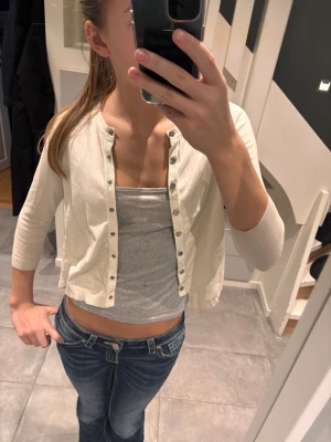 Beige/ krämvit kofta med volang - Jätte fin beige/ krämvit kofta med super fin volang detalj på ryggen🤍från Karen millen