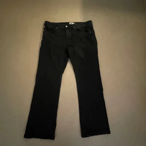 Svarta bootcut jeans - Svarta med klassisk femficksdesign och bootcut passform. Jeansen har normal midja och är tillverkade i slitstarkt denimtyg. Perfekta för dig som gillar en tidlös och clean look.