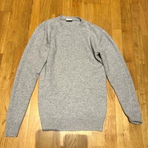 Ljusgrå stickad tröja John Henric - Säljer en stilren ljusgrå stickad tröja från John Henric. Tröjan är i storlek M men sitter lite mer som en M/S