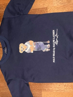 Mörkblå Polo Bear t-shirt Ralph Lauren - Snygg mörkblå sweater från Ralph Lauren med Polo Bear. Storleken är S och passar perfekt.