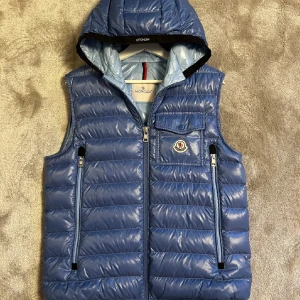 Moncler väst - Tja! Säljer nu denna sinnes sjukt snygga Moncler västen. Modellen heter Ragot. Västen är i storlek 2 vilket motsvarar S/M. Den är knappt använd och omhändertagen extremt bra, nyskick! Priset är ej hugget i sten så skicka prisförslag. Hör av dig vid minsta lilla fundering!