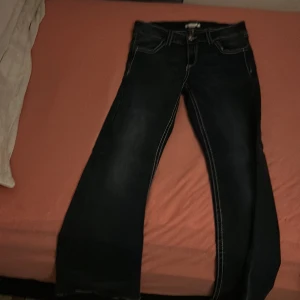 Mörkblå jeans med broderade fickor - Snygga mörkblå jeans från Gina Tricot med kontrastsömmar och broderade detaljer på bakfickorna. Modellen har raka ben och klassisk femficksdesign. Perfekt för dig som vill ha jeans med lite extra attityd och coola detaljer.