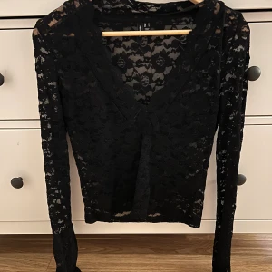 Svart spetsblus från Vero Moda - Säljer en svart långärmad blus från Vero Moda i spets med v-ringad hals. Aldrig använd men tyvärr har jag råkat ta bort prislappen🌸