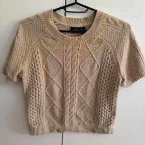 Kortärmad stickad tröja  - Kortärmad kabelstickad tröja från Kappahl som nyligen köptes på Sellpy. Tröjan är väldigt fin, mjuk och skön, men var tyvärr fel färg för mig. 