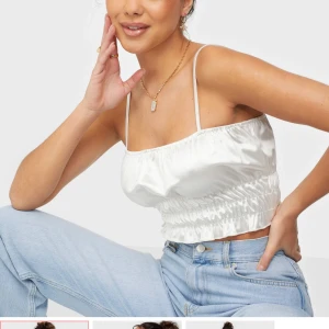 Topp från nelly  - Säljer denna topp från nelly i satin material. Färgen är kräm vit/beige/silvrig. Använd fåtal gånger. Köparen står för frakt