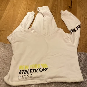 hoodie - vit hoodie med en neon svart text 