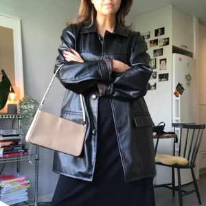 Skinnjacka - Lång jacka i läderimitation. Köpt helt ny på second hand och sedan dess sparsamt använd. Skavankfri! 