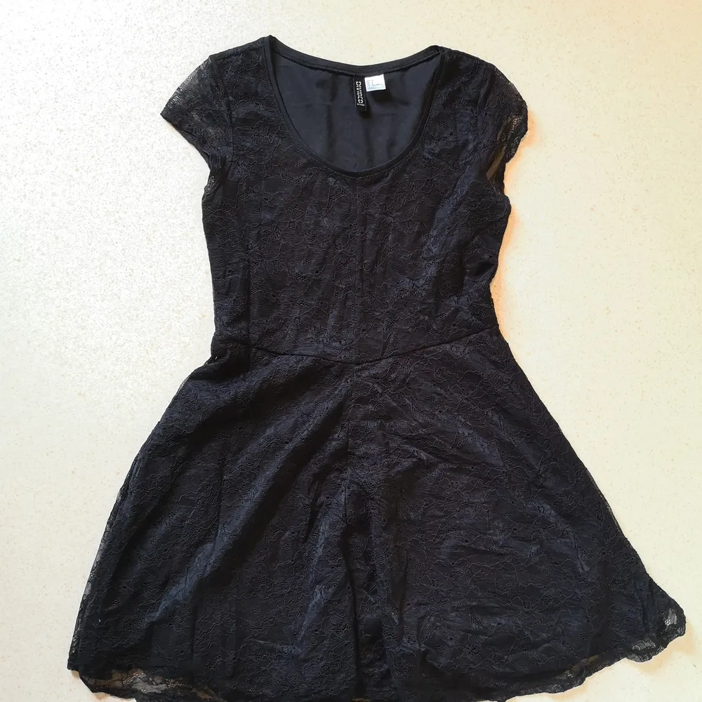Kortare svart spetsklänning ifrån HM. Sitter tight och fint på överkroppen och mer avslappnat utsvängt i kjolen. . Klänningar.
