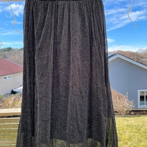 Kjol med glitter - Oanvänd kjol med två lager tyg, glitter i yttersta. Säljes pga flytt