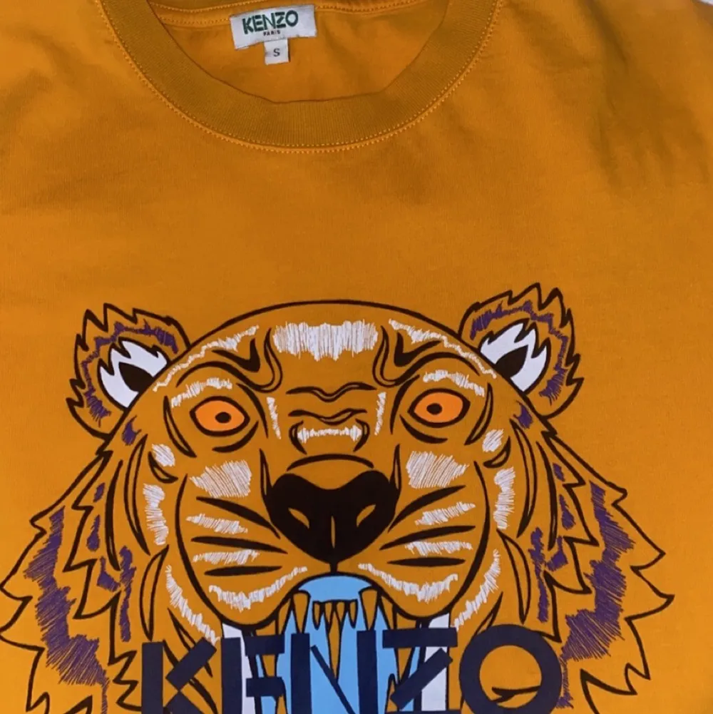 En kenzo Paris t-shirt i orange färg med fler färgad tiger på. Skicket på tröjan är 9-10 av 10 och är köpt på johnells. OBS KÖPAREN STÅR FÖR FRAKT . T-shirts.