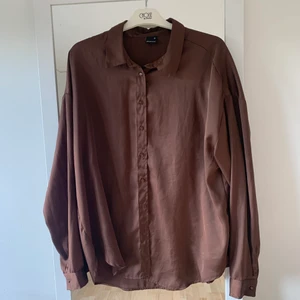 Brun skjorta  - Super fin lite oversist brun glansig skjorta! Använd 2-3 gånger så är i bra sick! Vid fler frågor bara skriv 😊 köparen står för frakt 🚚 