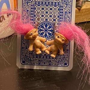 trolls earrings  - these cute trolls earring are one of my fave things im selling. About the size of a playmobile person (if you know what that is lmao) im having a hard time explaining how big they are but for reference the card they’re hanging on a normal playing card.  