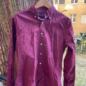 Ralph Lauren skjorta.  - Vinröd Ralph Lauren skjorta. Välanvänd men inte fläckig eller trasig. Pris kan diskuteras, måste hämtas idag PGA flytt.