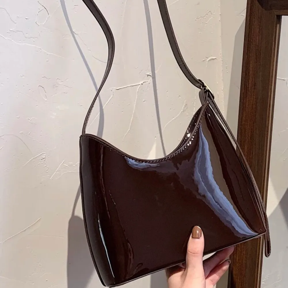 säljer denna bruna lack väskan med kort handtag som man ser på första bilden (väskan är alltså inte lång i bandet som på bild två✨) superfint skick då den aldrig är använd  🥰. Väskor.