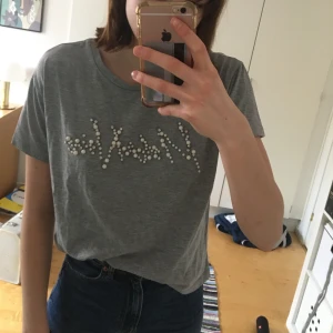 Tshirt med pärlmärke  - T-shirt med pärldekoration i storlek M. Jag köpte den i Spanien, från märker stradivarius. I bra skick🥰