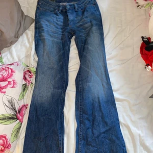 Blåa Diesel-jeans - Ett par blåa flare/svagt bootcut jeans från diesel med storlek 28 i midjan. Byxorna är ganska lågmidjade och små i storleken, så passar antagligen bättre någon som har storlek 26-27 i midja vanligtvis. Dessutom ganska långa i benen.